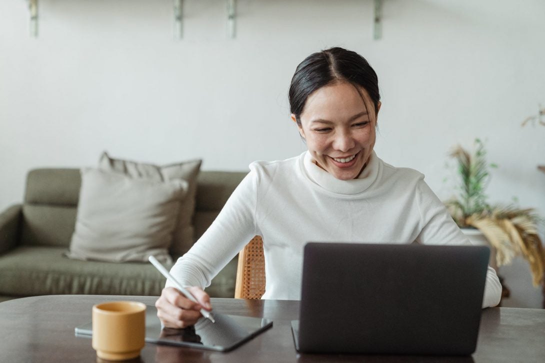 Woman smiling at laptop